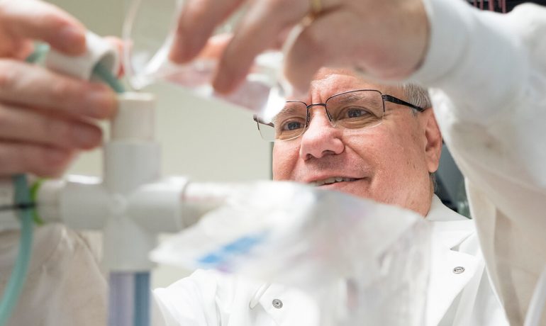 Researcher at NIA pours liquid in tube