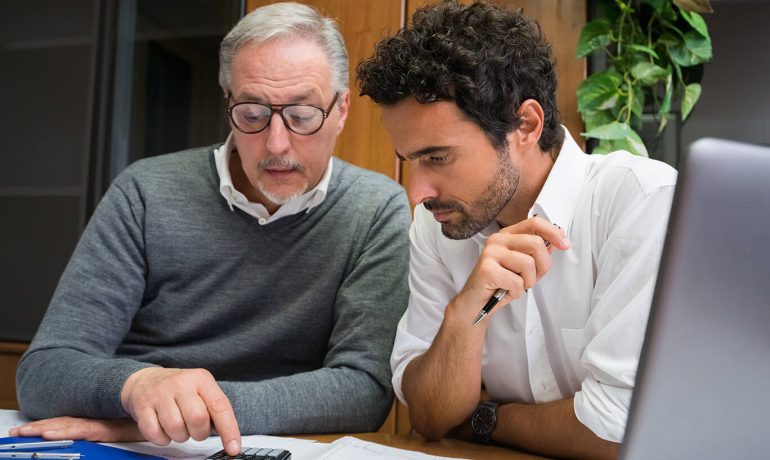 Engineers working together in an office checking over data